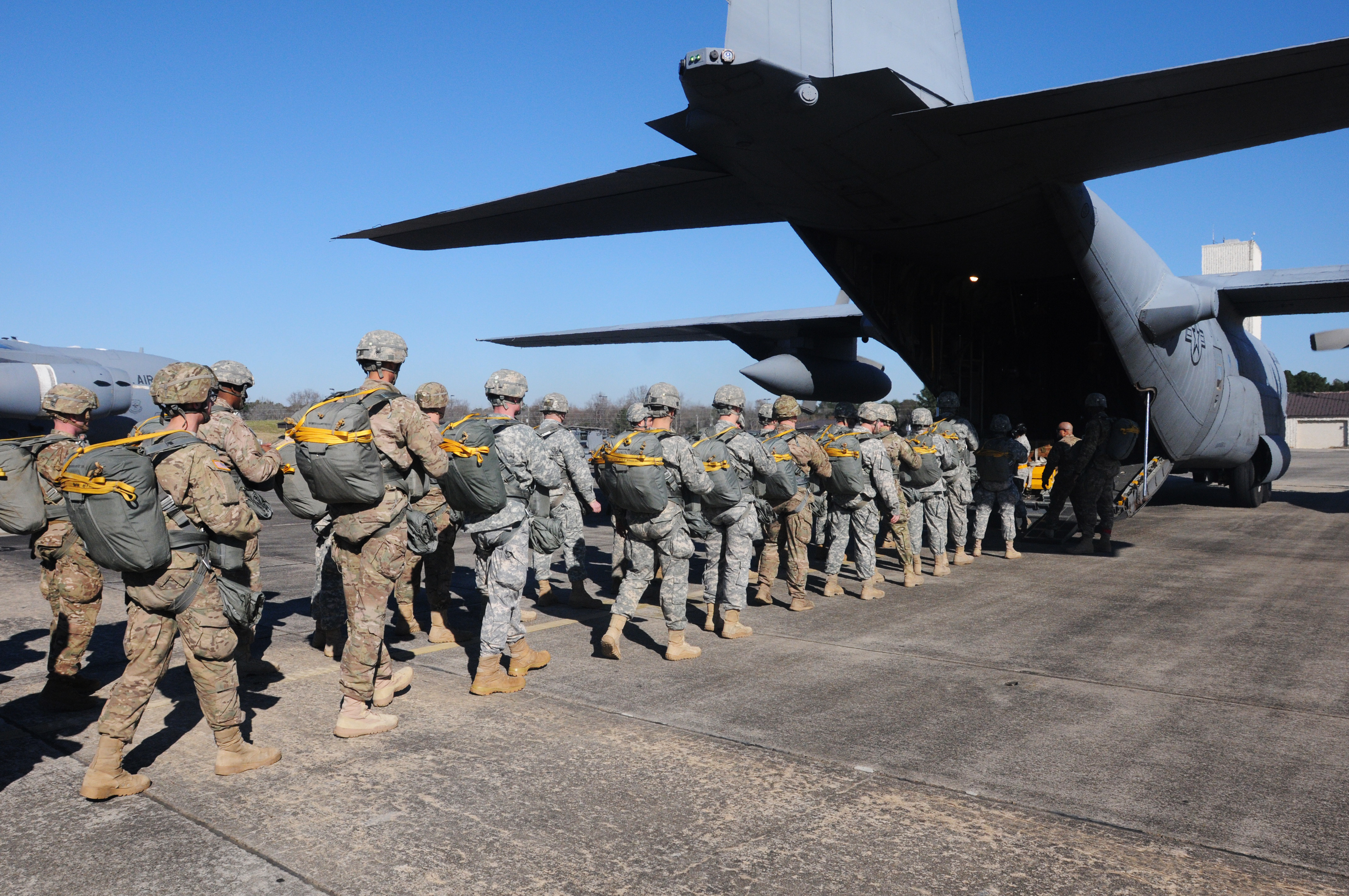Photo of a C-130 Loading Up with troops and their gear.